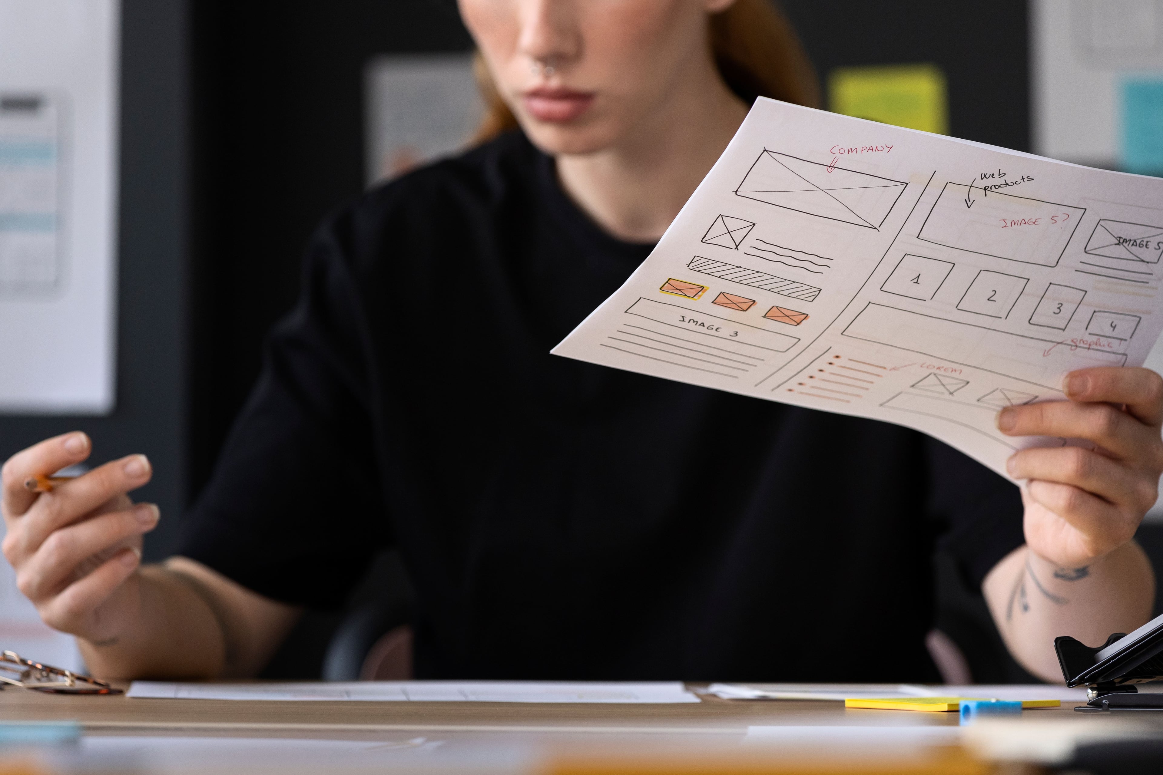 female-web-designer-with-papers-notes-office (1).jpg